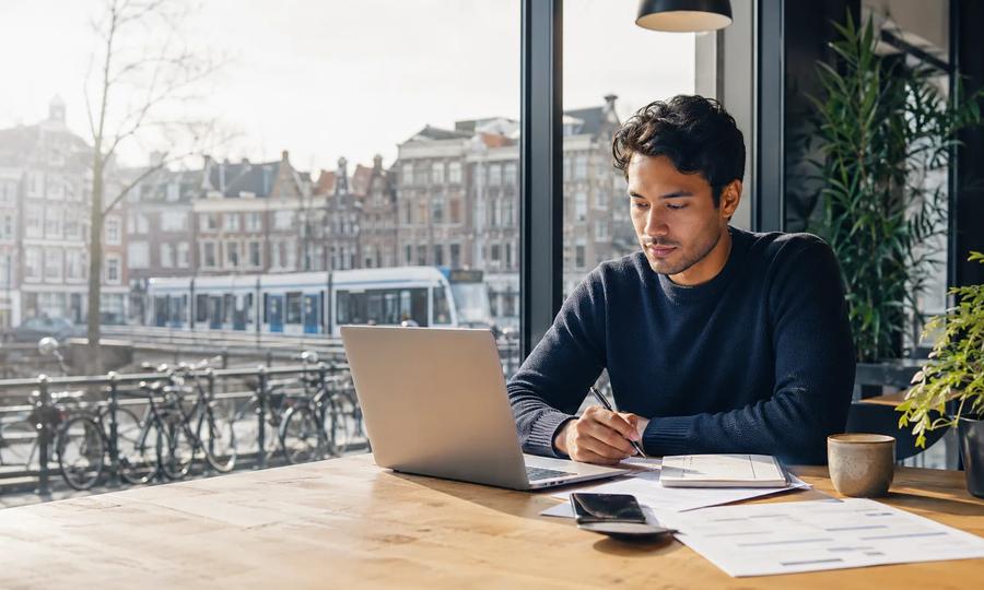 International job seeker in the Netherlands searching and applying for work on a laptop