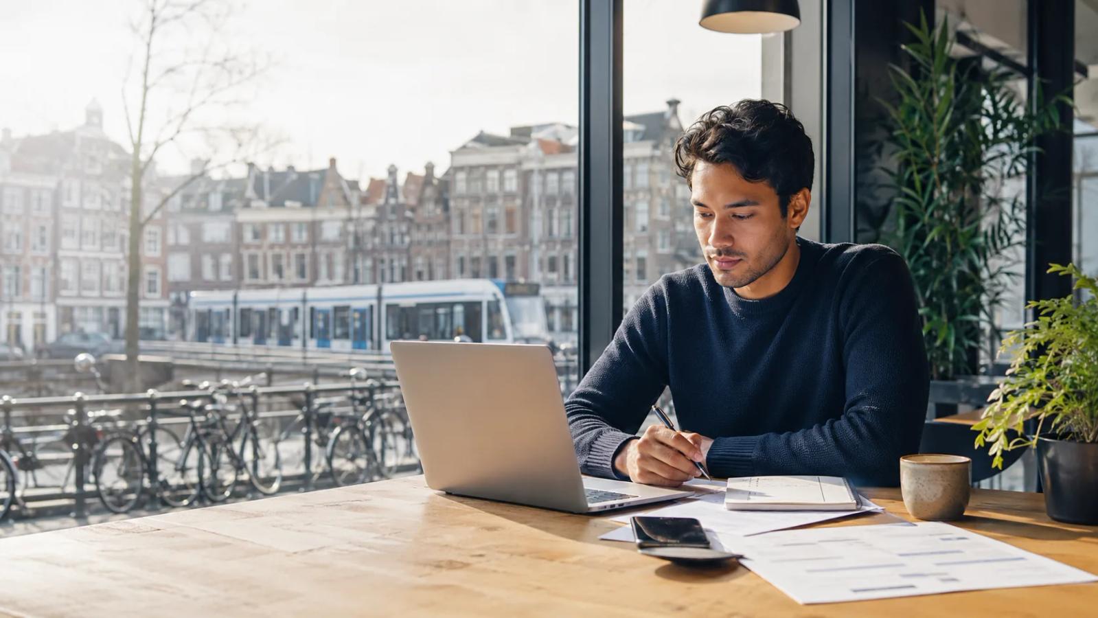 International job seeker in the Netherlands searching and applying for work on a laptop