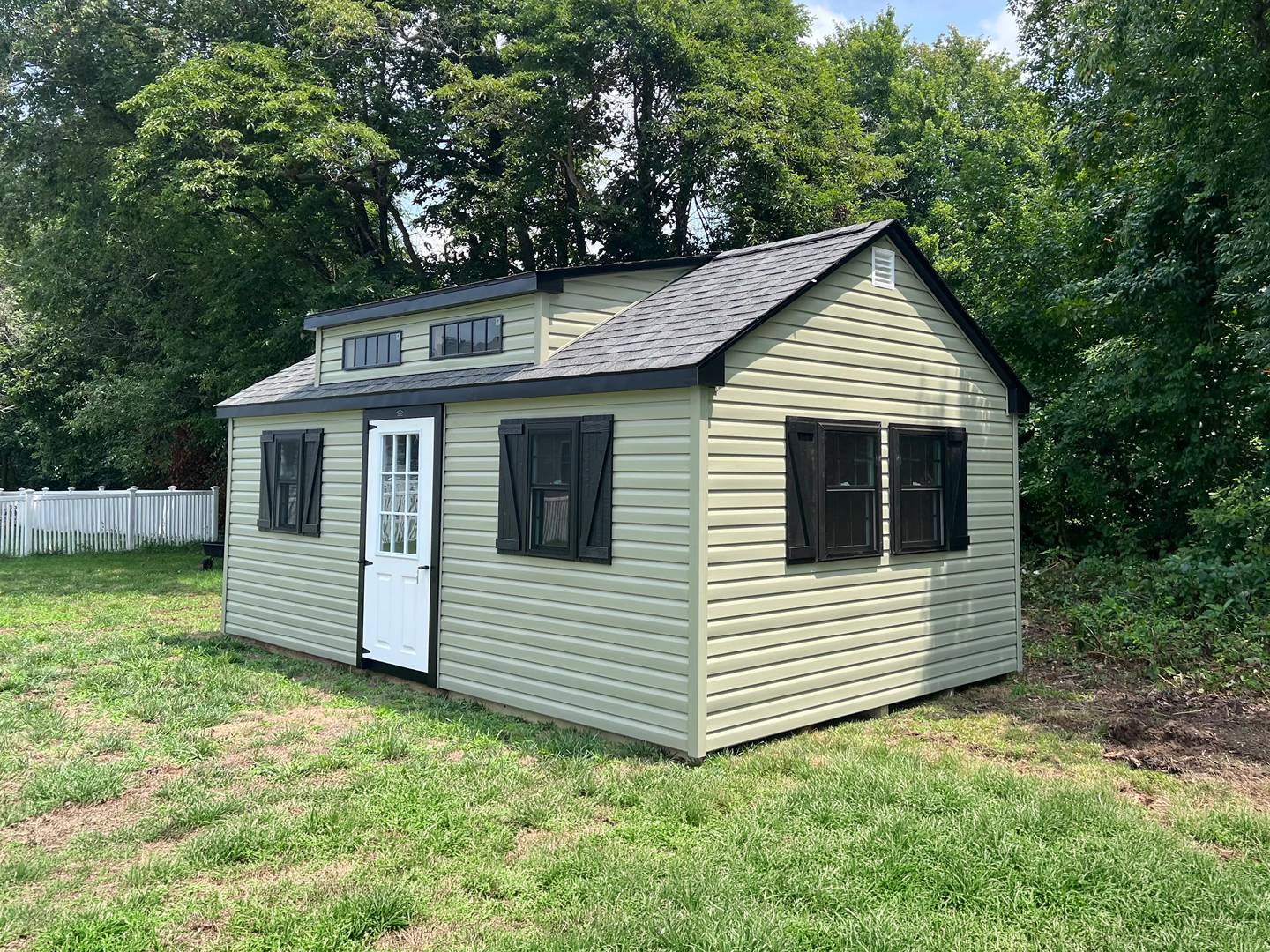 Sage green dormer shed with black shutters