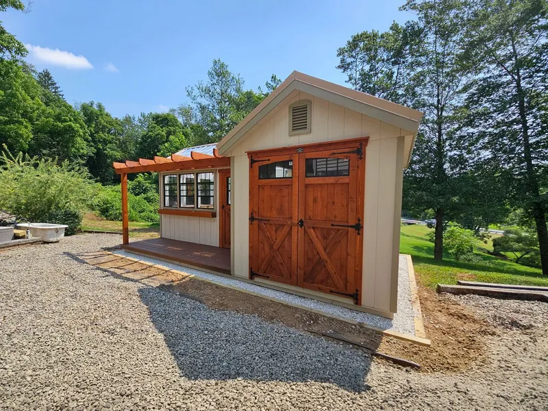 Garden shed with an attached greenhouse and a pergola porch