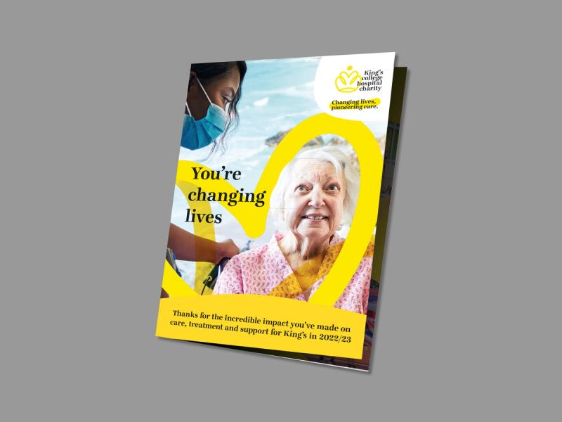 King's College Hospital Charity - Impact report mailer displaying an image of an elderly woman being cared for by a nurse with the message - You're changing lives.