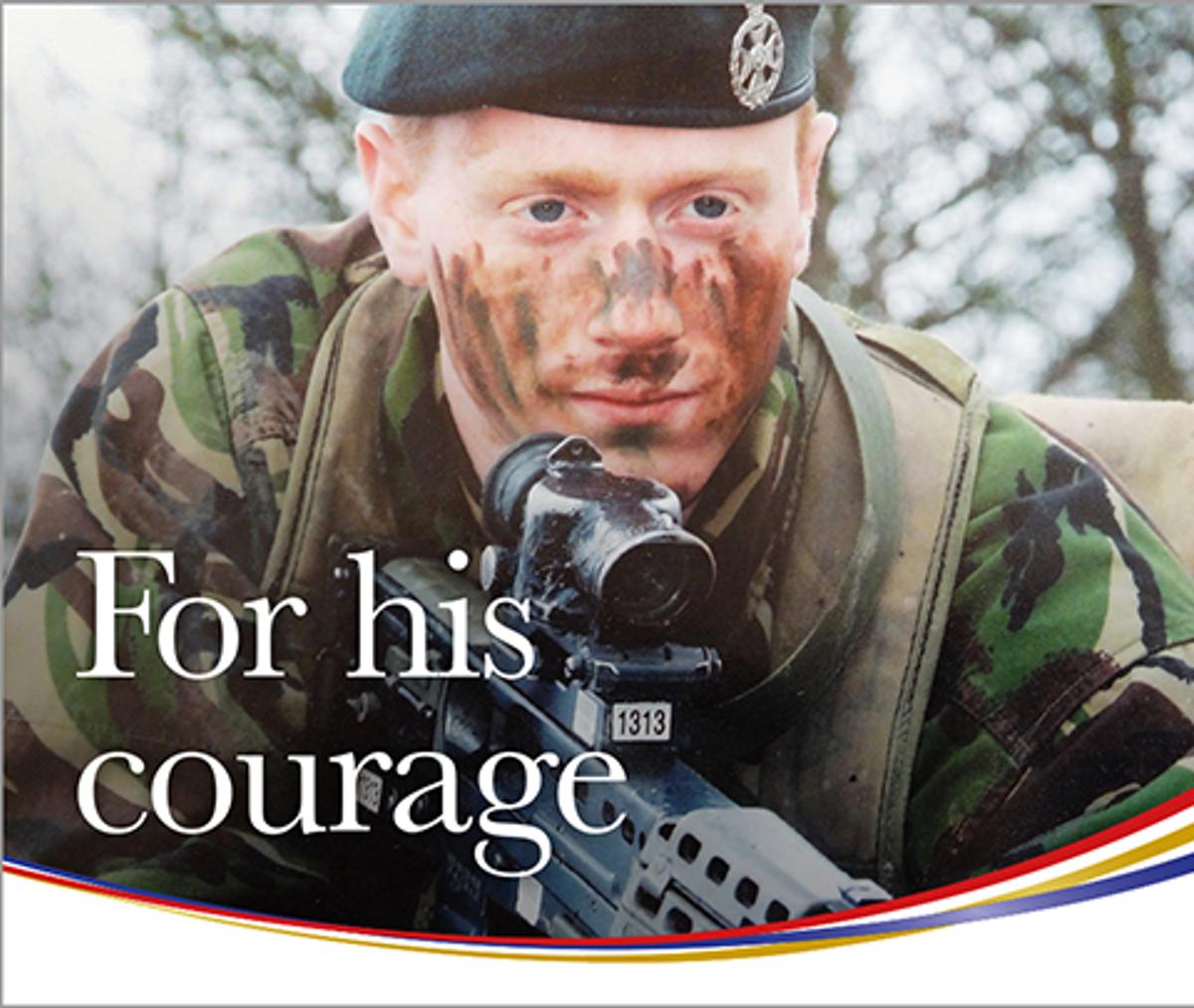 Royal Star & Garter - A relative close up of a young army veteran, Stephen, in fatigues holding a rifle while prone looking across the camera lens with the words "For his courage".