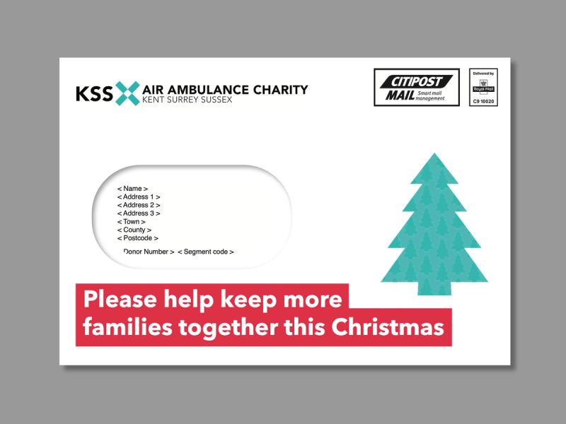 KSS Air Ambulance Christmas campaign envelope with a Christmas tree and the message - Please help keep more families together this Christmas.