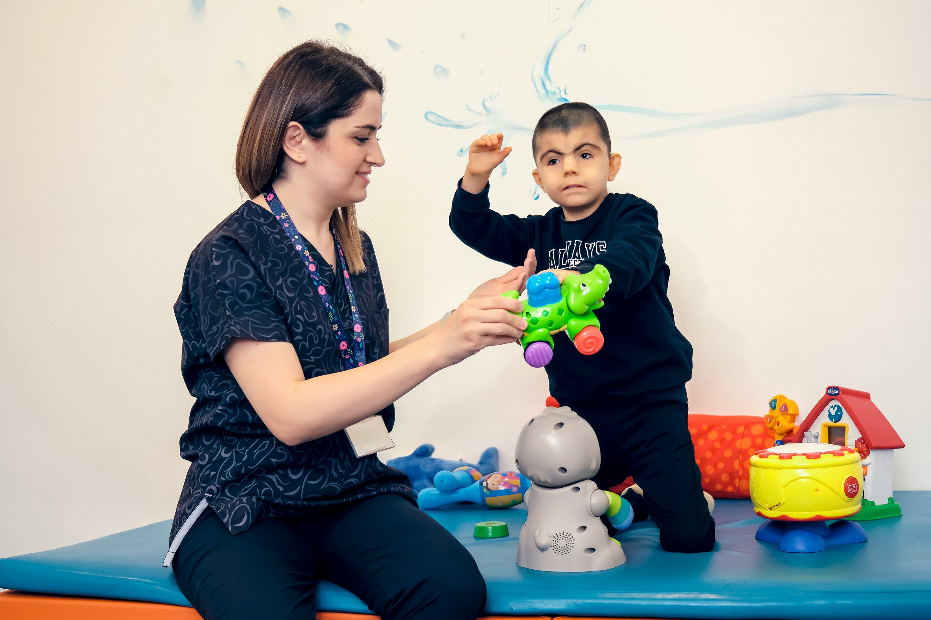 A child and therapist use toys during a play-based therapy session.