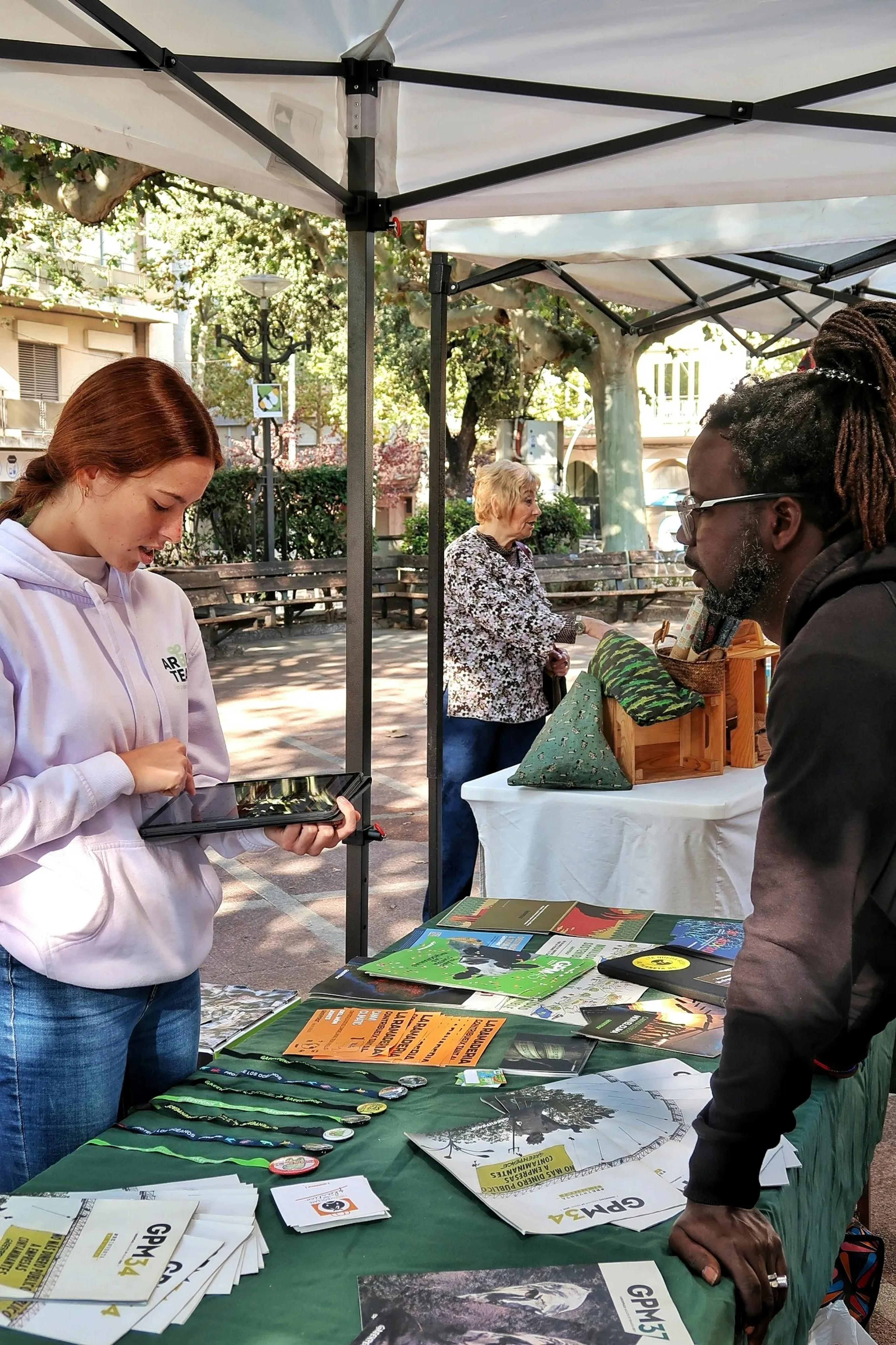 A person filling out a form at a nonprofits stand