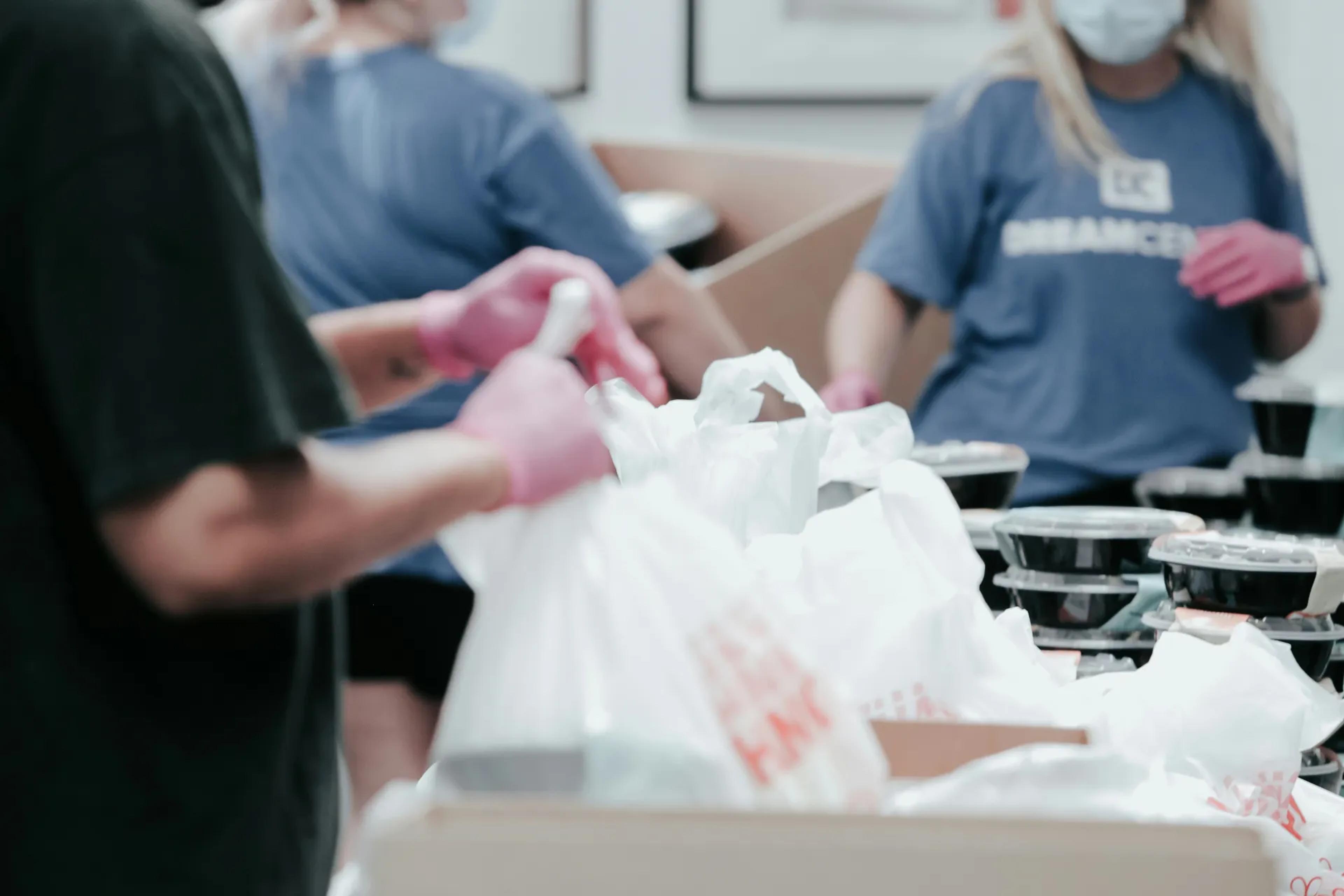 Peopling handling bags of food at a food bank