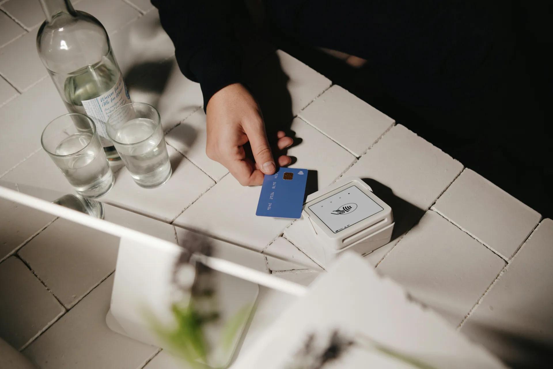 A person tapping there card at a small business 