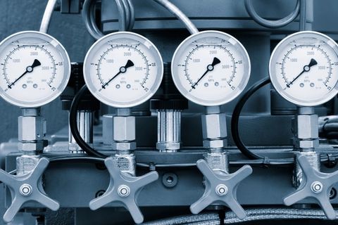 A macro photograph of a synchronized industrial gauge and valve stack, representing the transition from informal AI use to a sanctioned, governance-grade architecture.