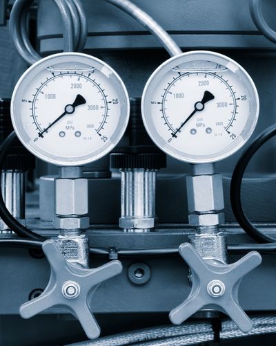 A macro photograph of a synchronized industrial gauge and valve stack, representing the transition from informal AI use to a sanctioned, governance-grade architecture.