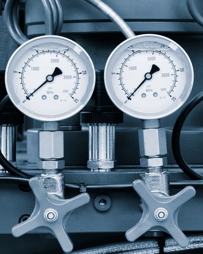 A macro photograph of a synchronized industrial gauge and valve stack, representing the transition from informal AI use to a sanctioned, governance-grade architecture.