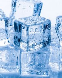 Several glistening, clear blue ice cubes stacked in a pile, beaded with condensation, slowly melting, representing anonymity that erodes over time.