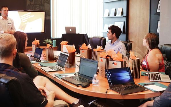 Business meeting, comparing backed loans versus standard loans for SMEs.