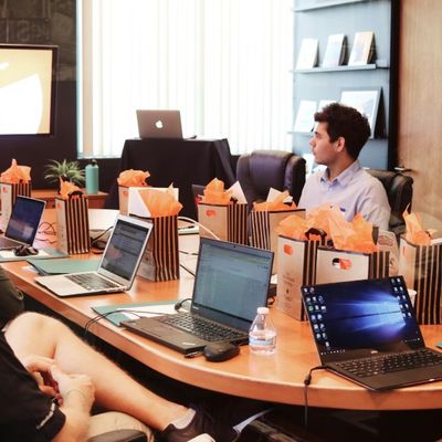 Business meeting, comparing backed loans versus standard loans for SMEs.