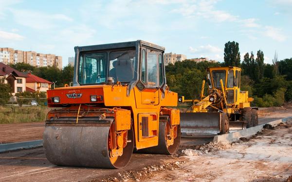 Road roller and grader machinery working on construction site in Ireland — heavy equipment for roadworks, civil engineering, and plant finance
