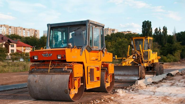 Road roller and grader machinery working on construction site in Ireland — heavy equipment for roadworks, civil engineering, and plant finance