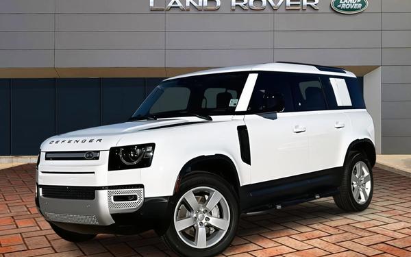 hite Land Rover Defender SUV parked outside Land Rover dealership in Ireland — premium 4x4 vehicle for business and personal finance options