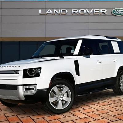 hite Land Rover Defender SUV parked outside Land Rover dealership in Ireland — premium 4x4 vehicle for business and personal finance options
