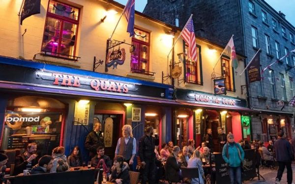 busy Irish pub with people socialising, reflecting Ireland’s community, tourism, and small-business support schemes available in 2026.