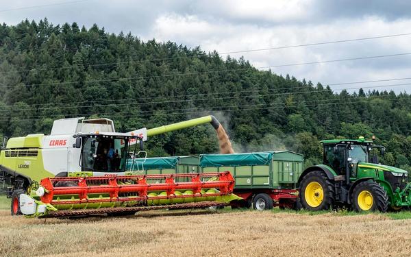 Claas combine harvester and John Deere tractor working on Irish farmland — agricultural machinery used for farming, harvesting, and equipment finance in Ireland