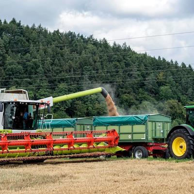 Claas combine harvester and John Deere tractor working on Irish farmland — agricultural machinery used for farming, harvesting, and equipment finance in Ireland