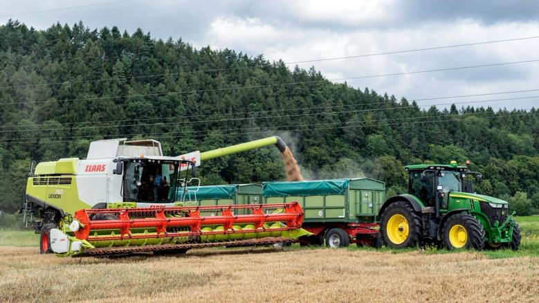 Claas combine harvester and John Deere tractor working on Irish farmland — agricultural machinery used for farming, harvesting, and equipment finance in Ireland