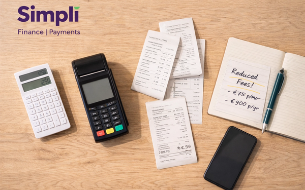 Overhead view of a light wooden desk with a black card terminal, white calculator, several receipts, a notebook with handwritten savings notes, a pen, and a smartphone, with the purple Simplí Finance | Payments logo in the top left corner.