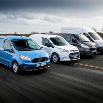 leet of Ford Transit vans driving on an Irish road — commercial vehicles for business delivery, logistics, and van finance in Ireland