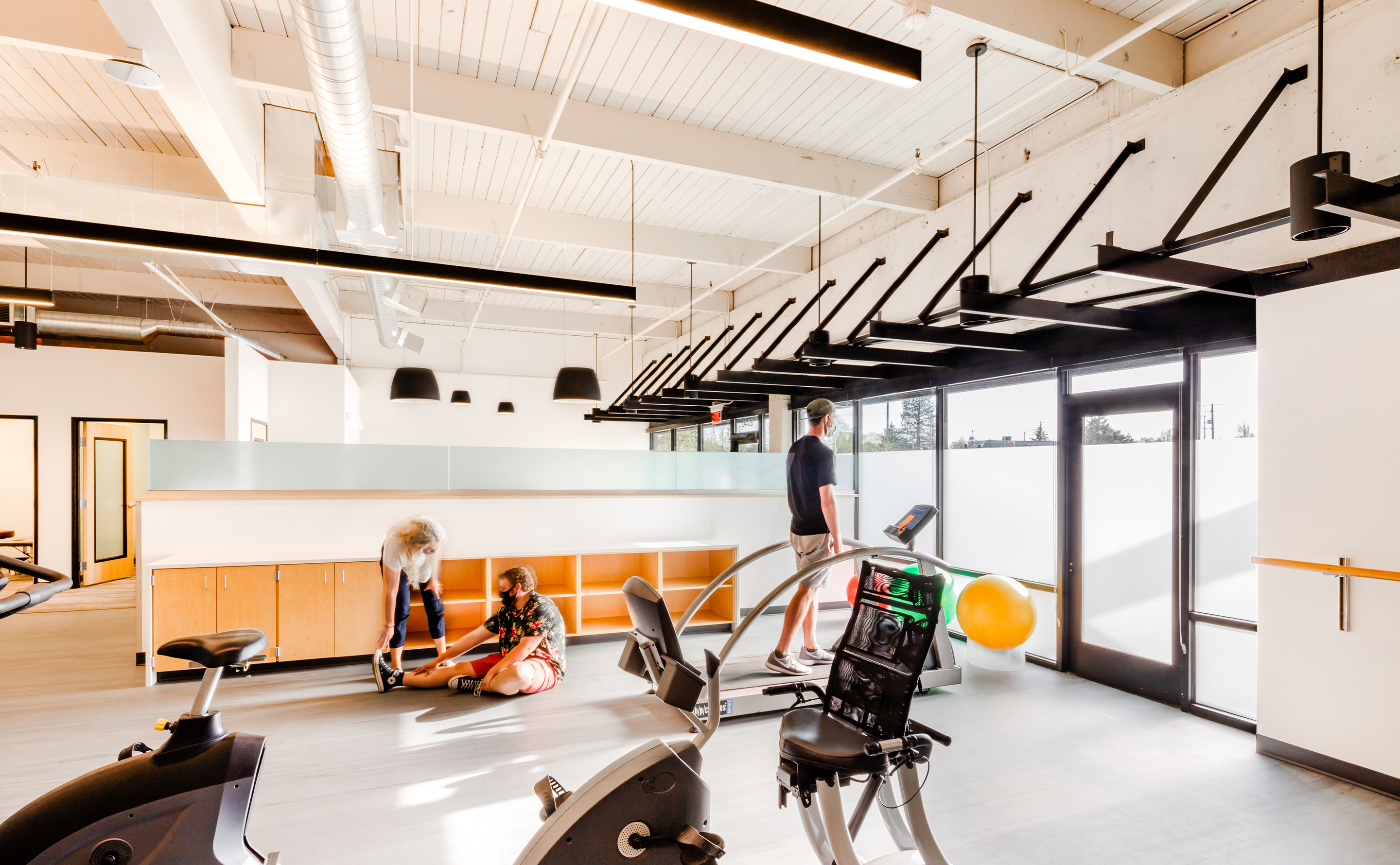 Looking at the PT area with windows and workout machines, 
