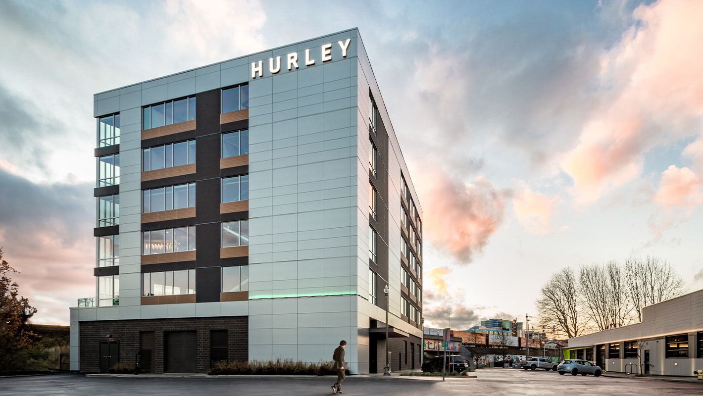 An outside shot of the Hurley Building Downtown Vancouver with a sunset sky