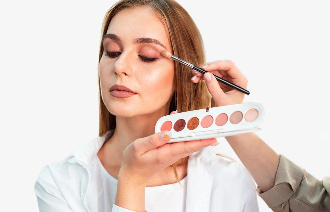 a woman applying different shades of eye 