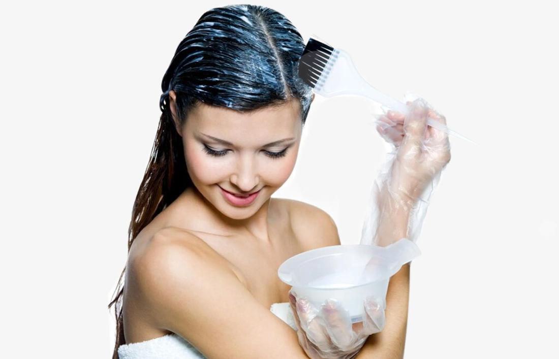 A woman applying dye on her hair
