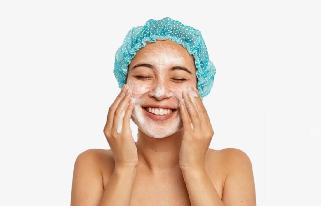 A woman scrubbing her face