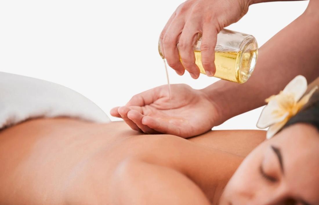 A woman getting a olive oil massage