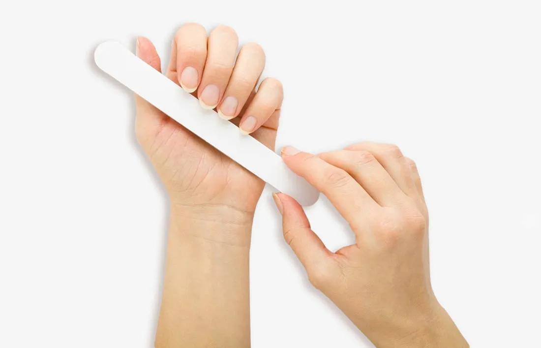 A woman Preparing her nails by trimming for nail art