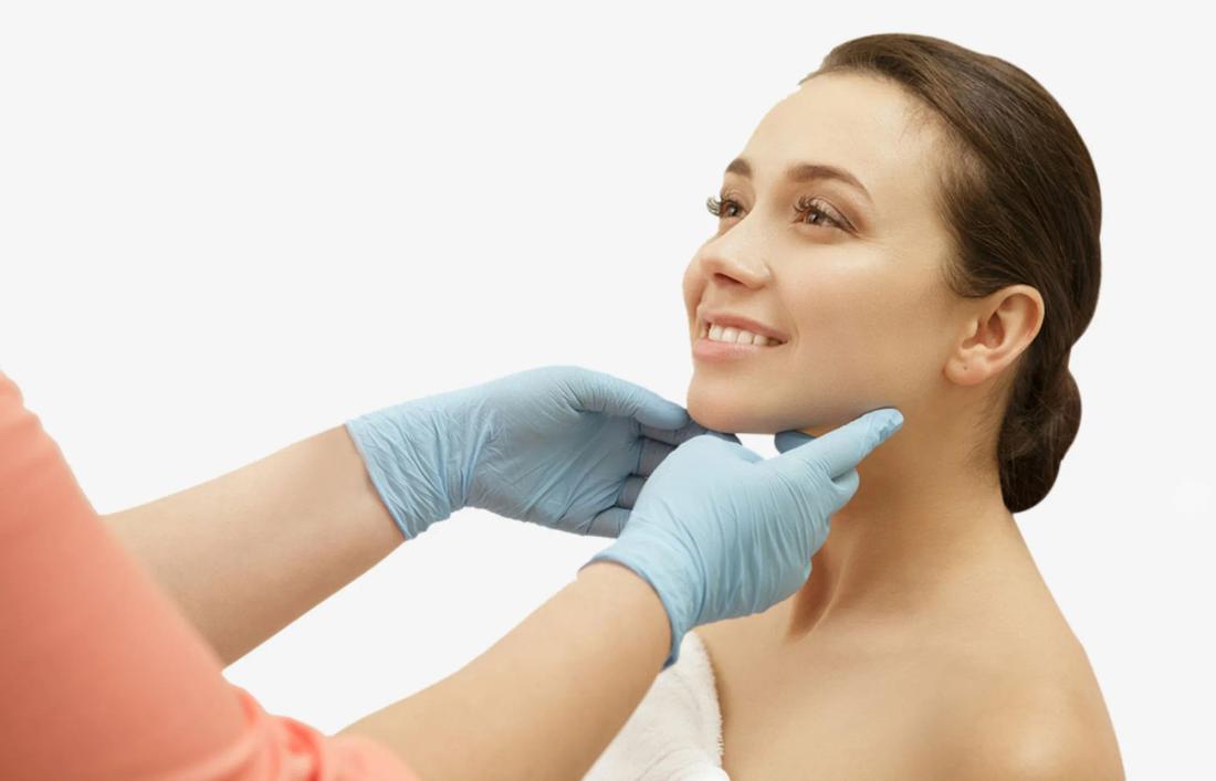A professional holding a smiling women face from her chin