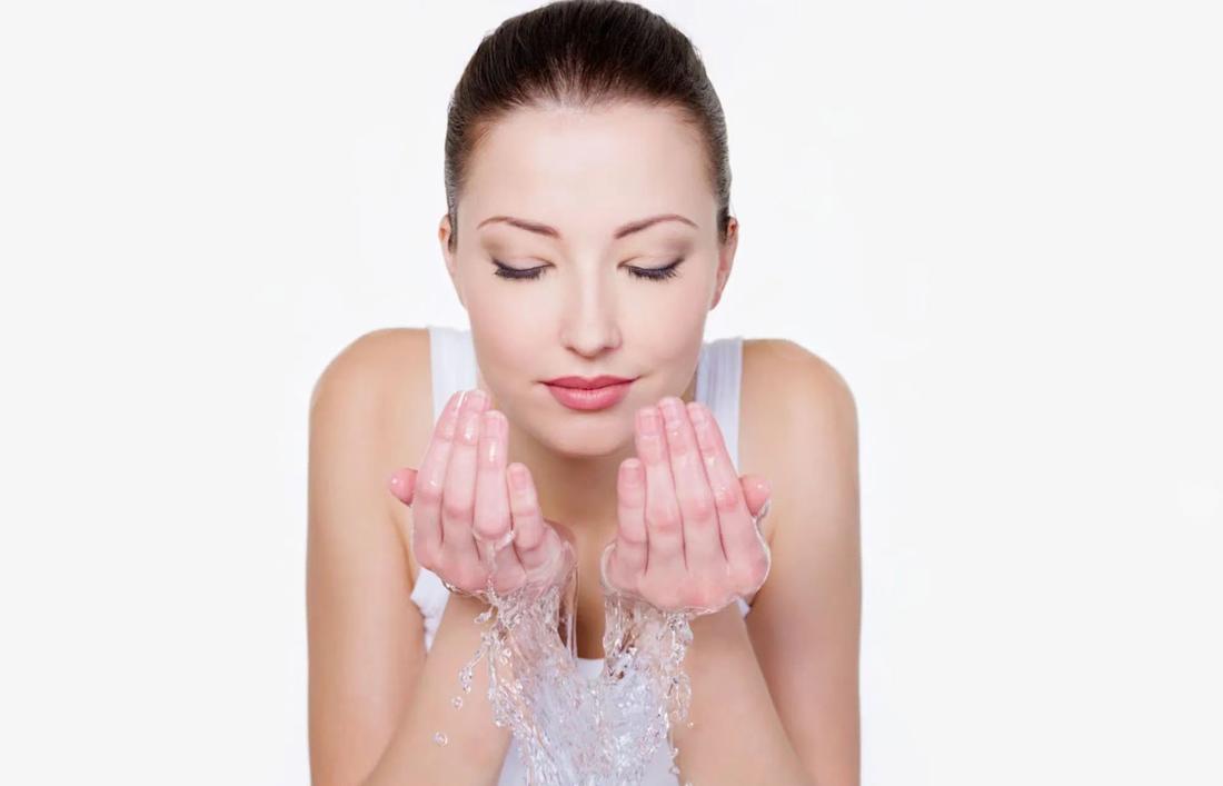 A Woman washing her face after having facial