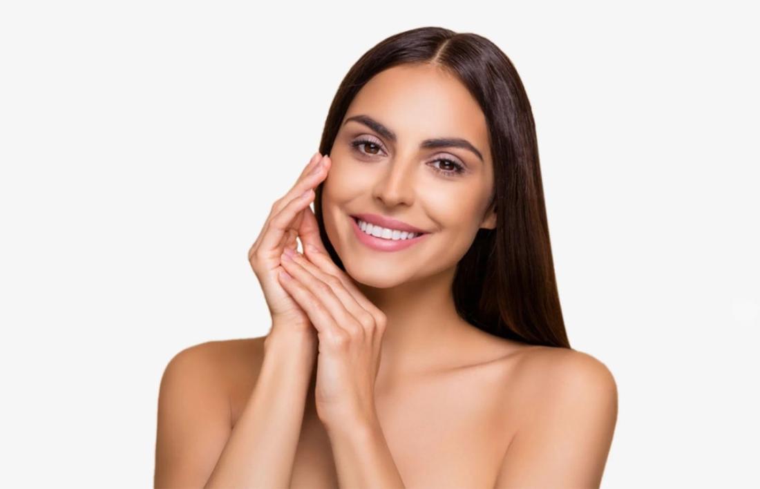 A woman smiling as she founded her skin type