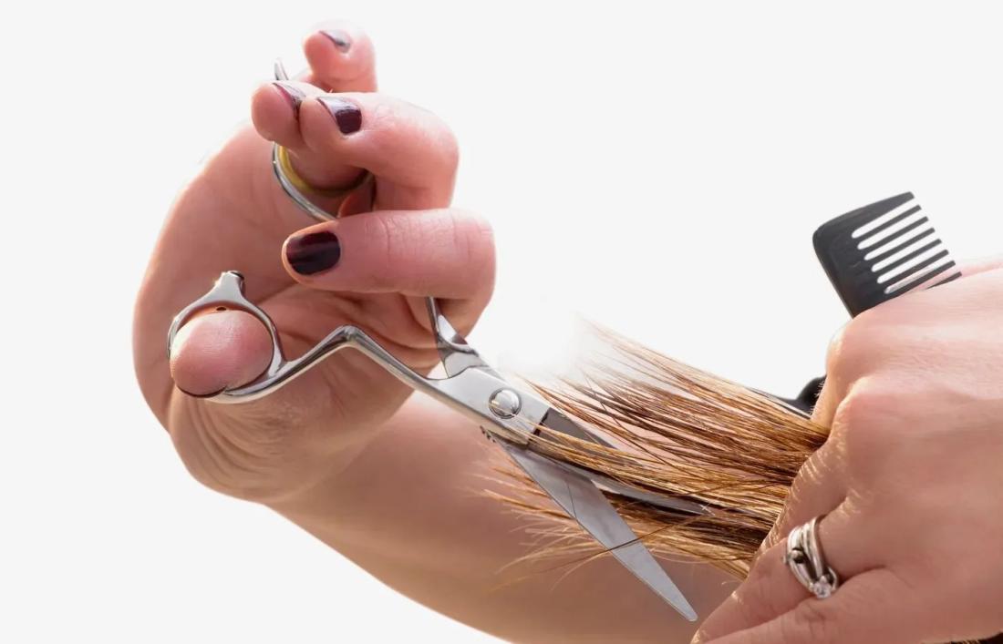 A Girl trimming her Hair