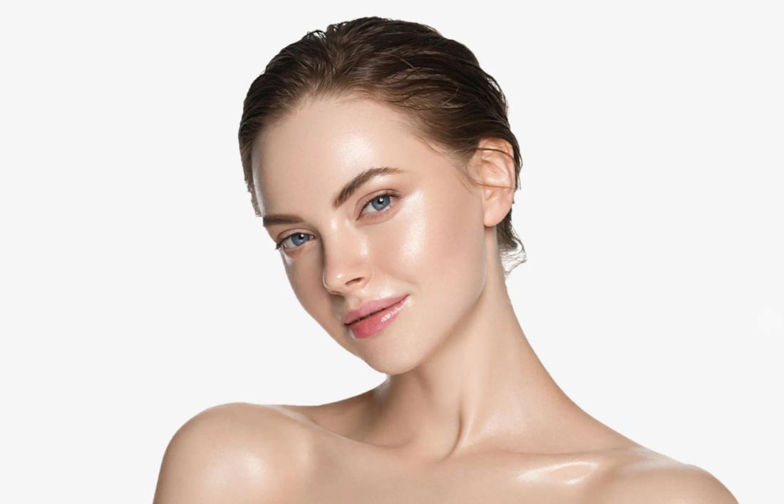 A woman with bright glowing space and a beautiful smile after a facial