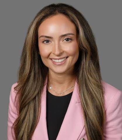 Dr. Jessica Vitale smiling in a pink blazer