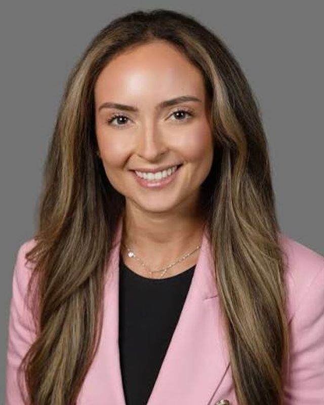 Dr. Jessica Vitale smiling in a pink blazer
