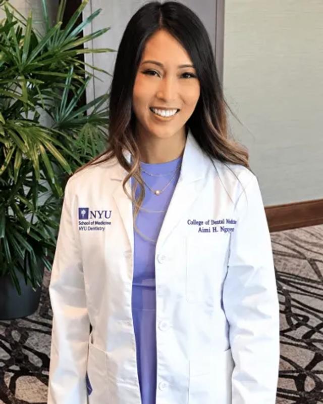 Dr. Aimi Nguyen smiling in her white coat