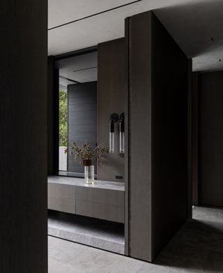 Moody scene in a high end architectural ensuite bathroom on the mornington peninsula, featuring curved flush electrical