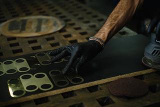 Metal worker handles quality brass faceplates in production and preparation of ZETR CARBON