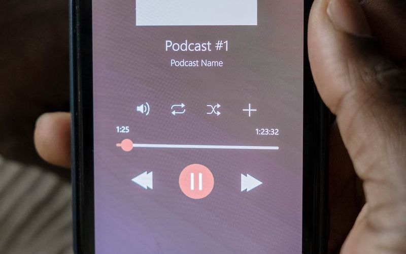 Pessoa com fones de ouvido em estúdio de gravação de conteúdo áudio