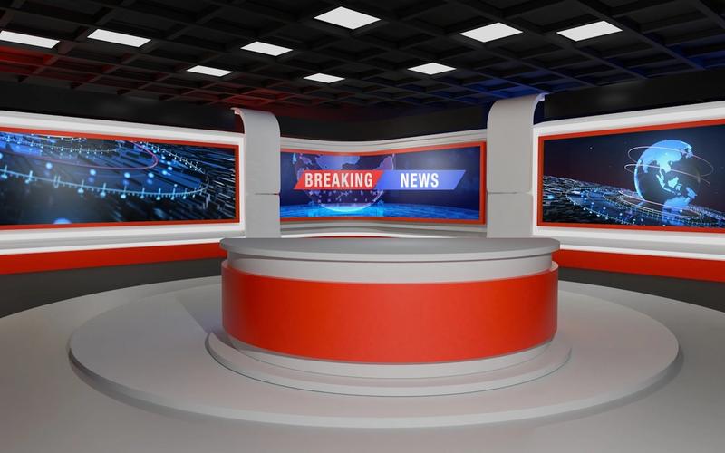 Estúdio de televisão moderno, iluminado, com bancada e telas ao fundo, pronto para receber um apresentador diante das câmeras.