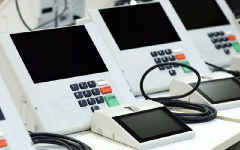 Urna eletrônica sendo inspecionada em laboratório de universidade