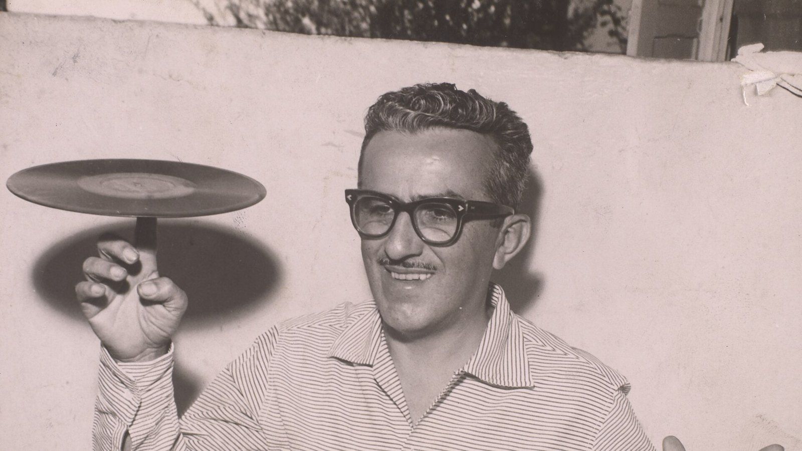 O apresentador Chacrinha (Abelardo Barbosa) equilibrando um disco de vinil na ponta do dedo, em foto de 1961.