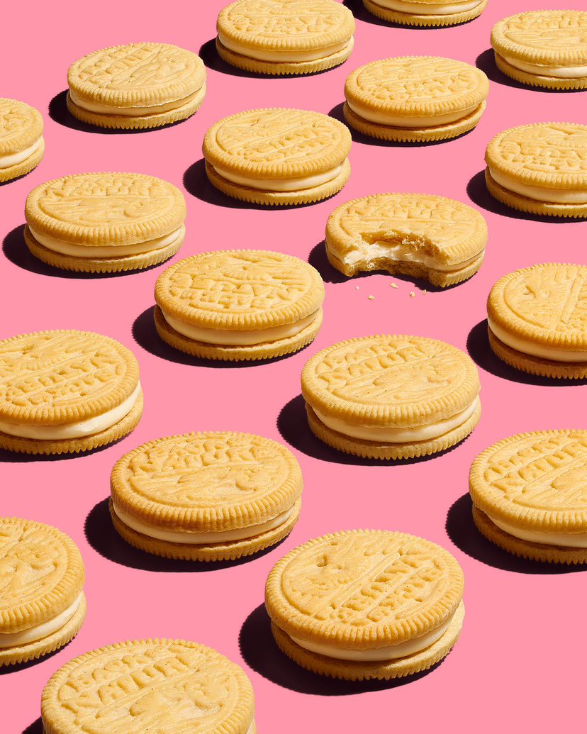 Golden creme cookies on a pink background