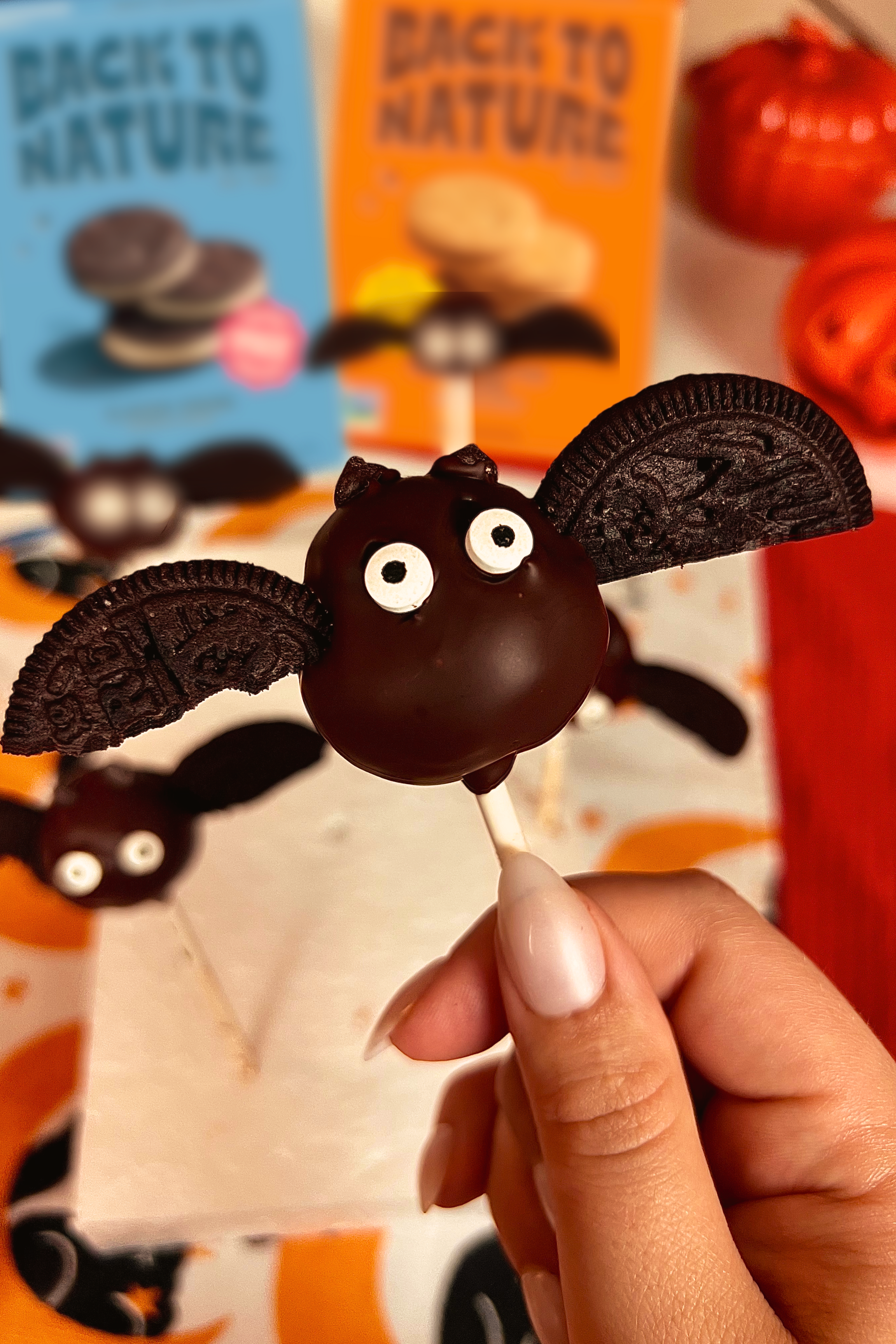 Cake pop shaped like bat with cookie wings